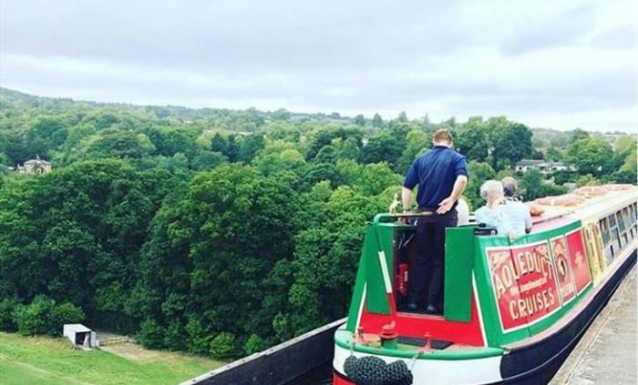 In this scene, Llangollen Wharf's Motorised Canal Boat Thomas Telford is crossing the Poncysyllte Aqueduct and passengers are taking in the stunning v